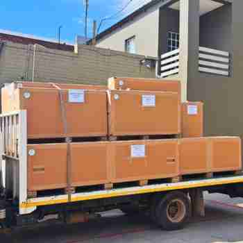 Different-sized Rebul crates with pallets stacked onto a trailer for transport